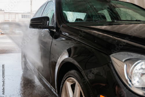  Car wash. Cleaning car using high pressure water. © Dmytro Flisak