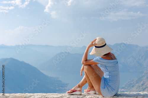 Beautiful girl looks at the bay of Kotor panorama. photo