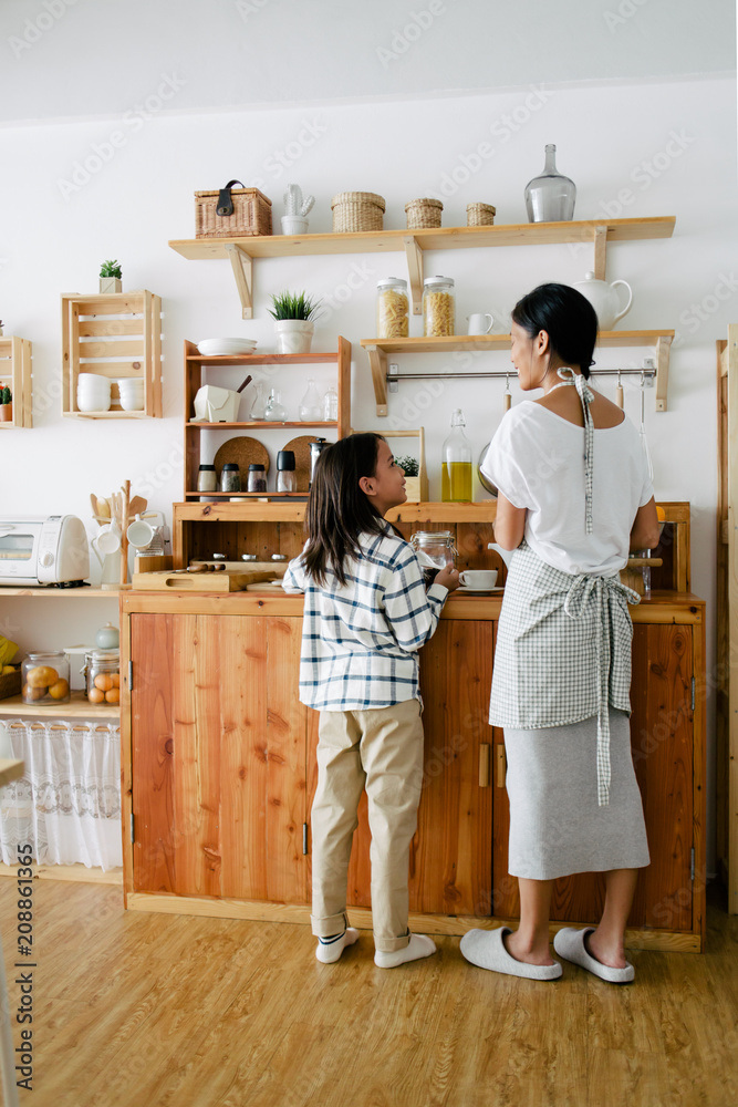 Asian mom and kid in the kitchen