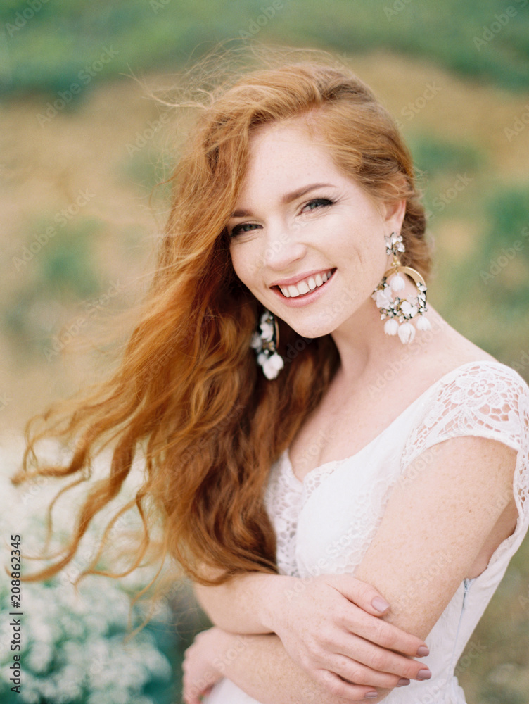 Smiling girl in dress and earrings posing Smiling girl in dress and earrings posing