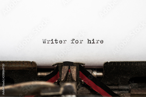 Message Writer for hire typed on white paper. Antique typewriter has a nostalgic, honest fee. Business concepts of copywriter, edit, write