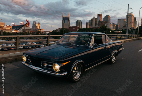 classic car transportation driving across bridge in Nashville Tennessee at sunset photo