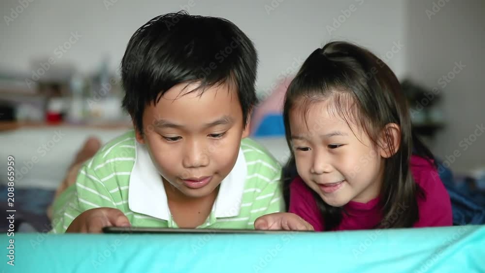 Asian children using digital tablet. E-learning concept. Asian children using digital tablet. E-learning concept.