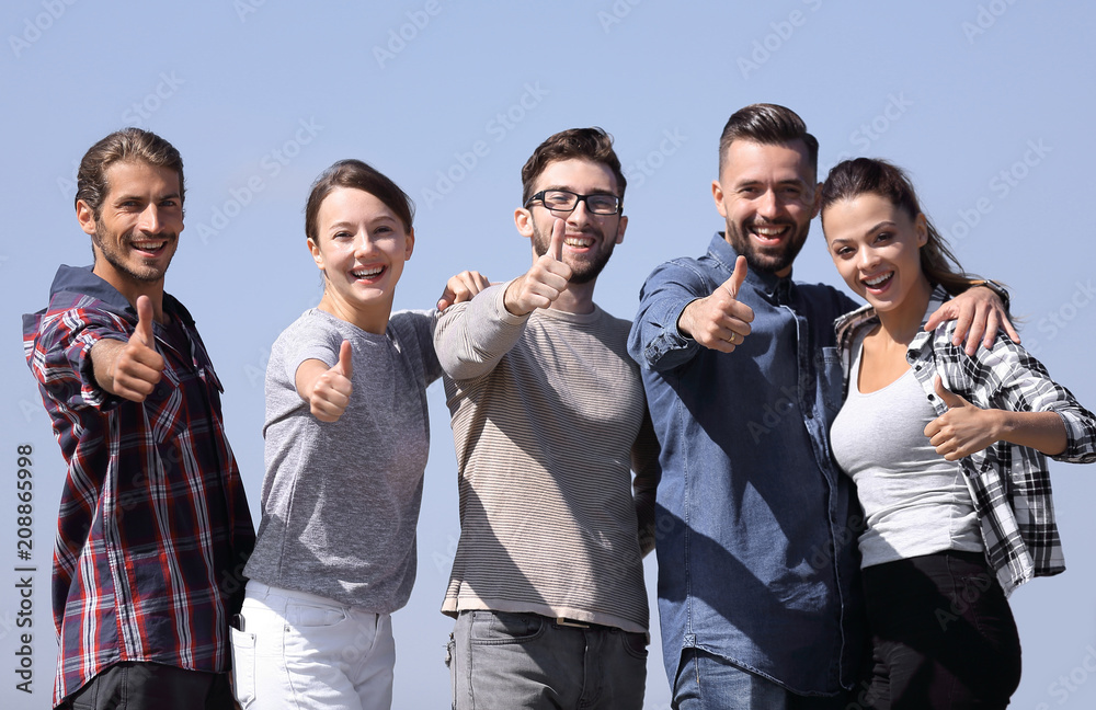 group of young people showing thumb up group of young people showing thumb up