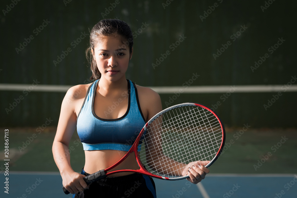 Young woman asia holding tennis racket.