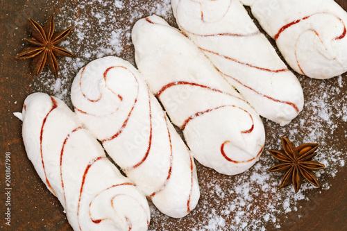 White vanilla zephyr  with powdered sugar. Sweet dessert. Top view. photo