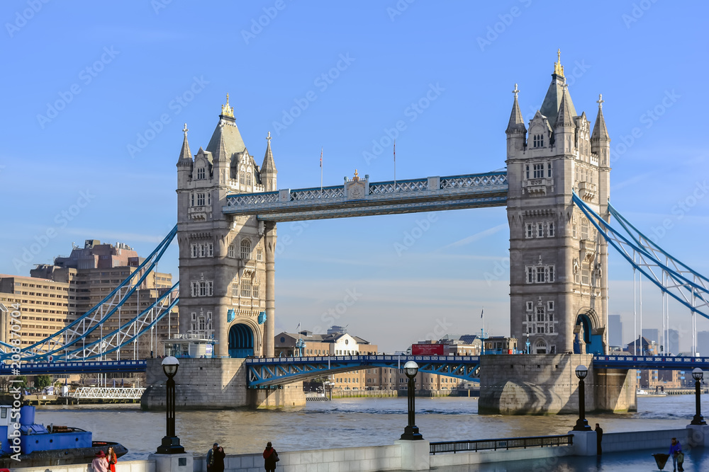 Fototapeta premium Tower Bridge against the winter blue sky. The bascule and suspension bridge crosses the River Thames and has become an iconic symbol of London.
