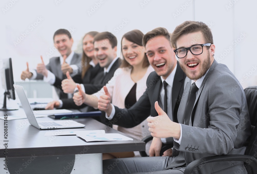 business team with thumbs up while sitting at his Desk business team with thumbs up while sitting at his Desk
