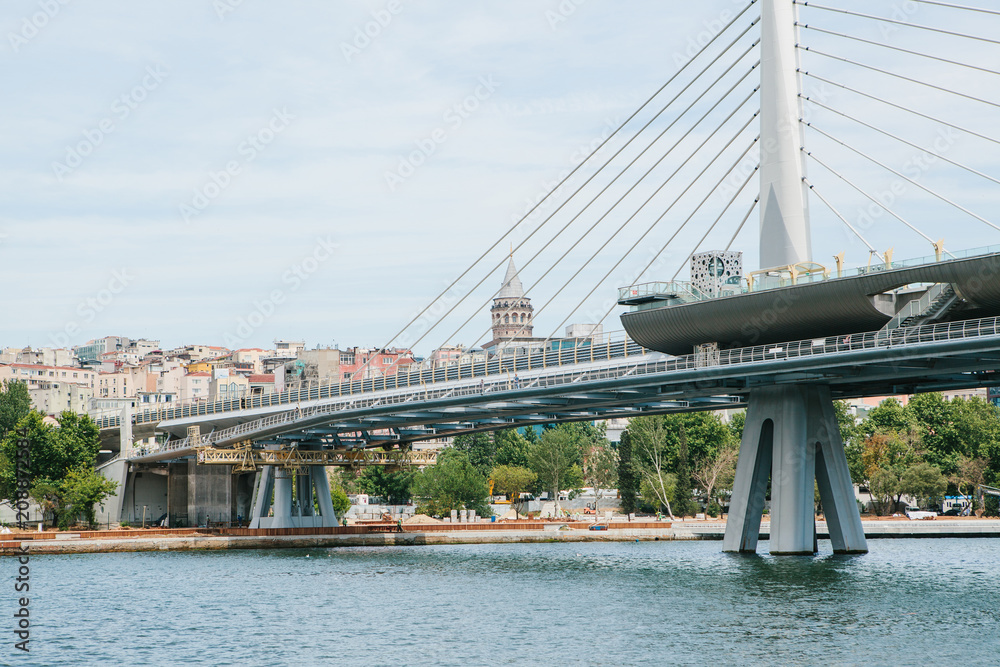 Obraz premium Part of the bridge in Istanbul connecting the Asian part with the European part of the city. The architecture of Istanbul is on the background