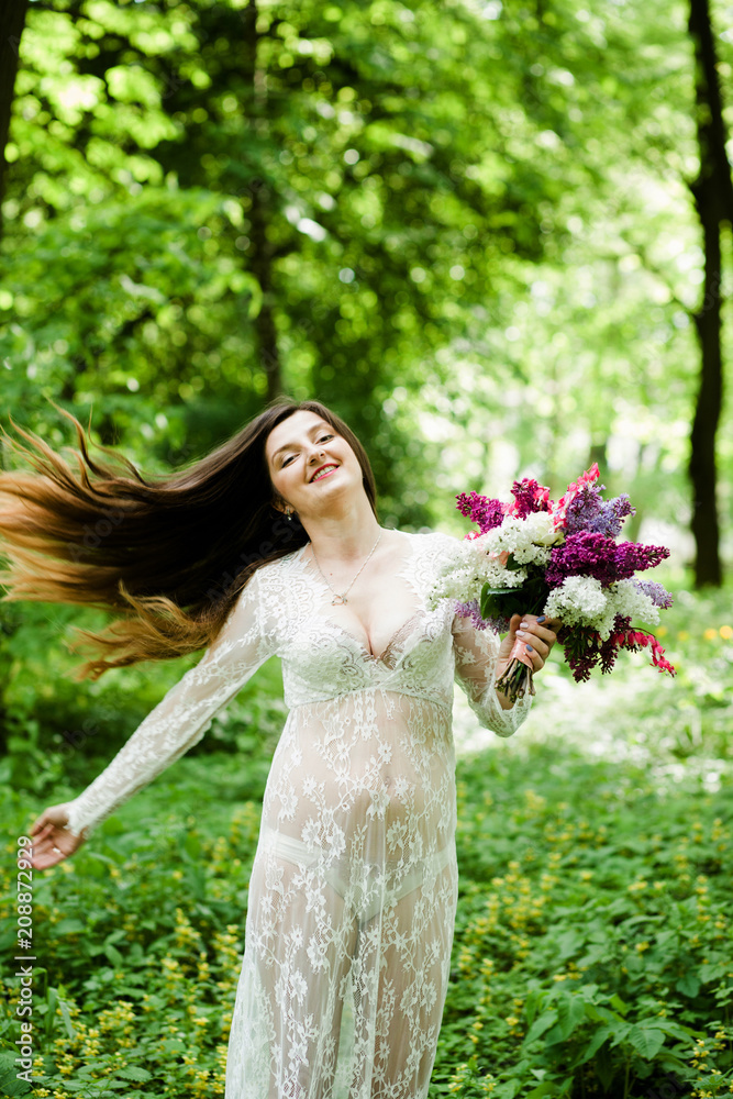 An emotional bride with long hair standing in the park