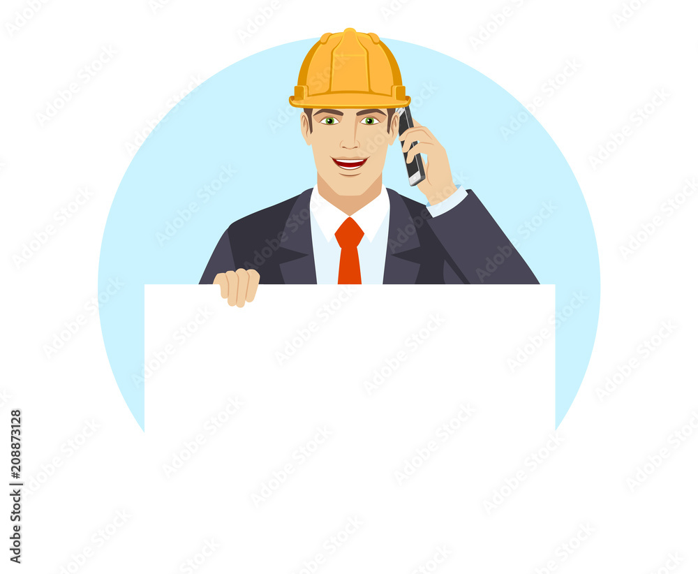 Businessman in construction helmet holding white blank poster and talking on the mobile phone Businessman in construction helmet holding white blank poster and talking on the mobile phone