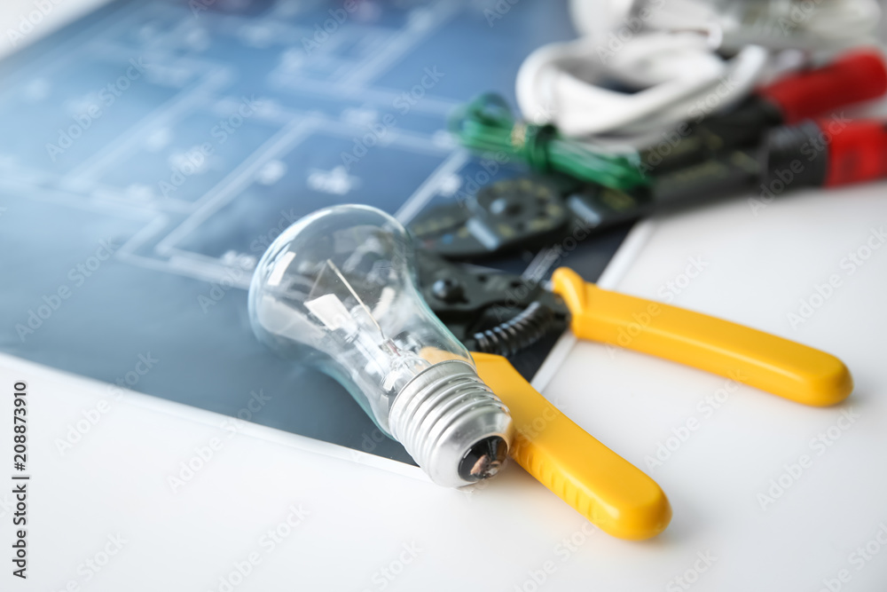 Electrician's supplies with electrical scheme on white background, closeup Electrician's supplies with electrical scheme on white background, closeup