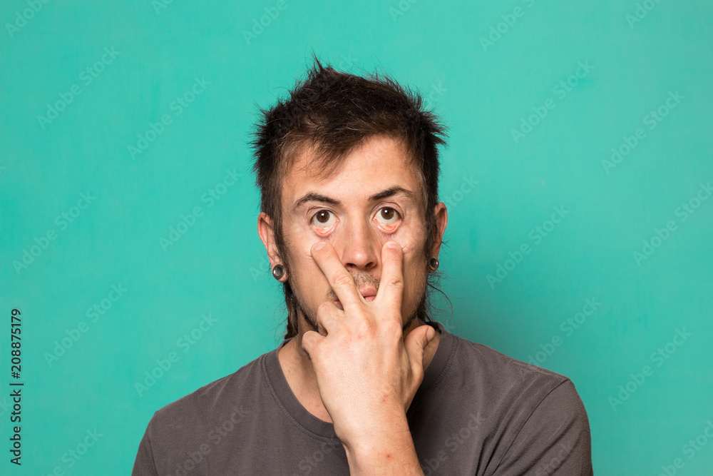 A modern bearded guy making a funny expression. A modern bearded guy making a funny expression.