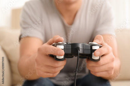 Young man playing video games at home