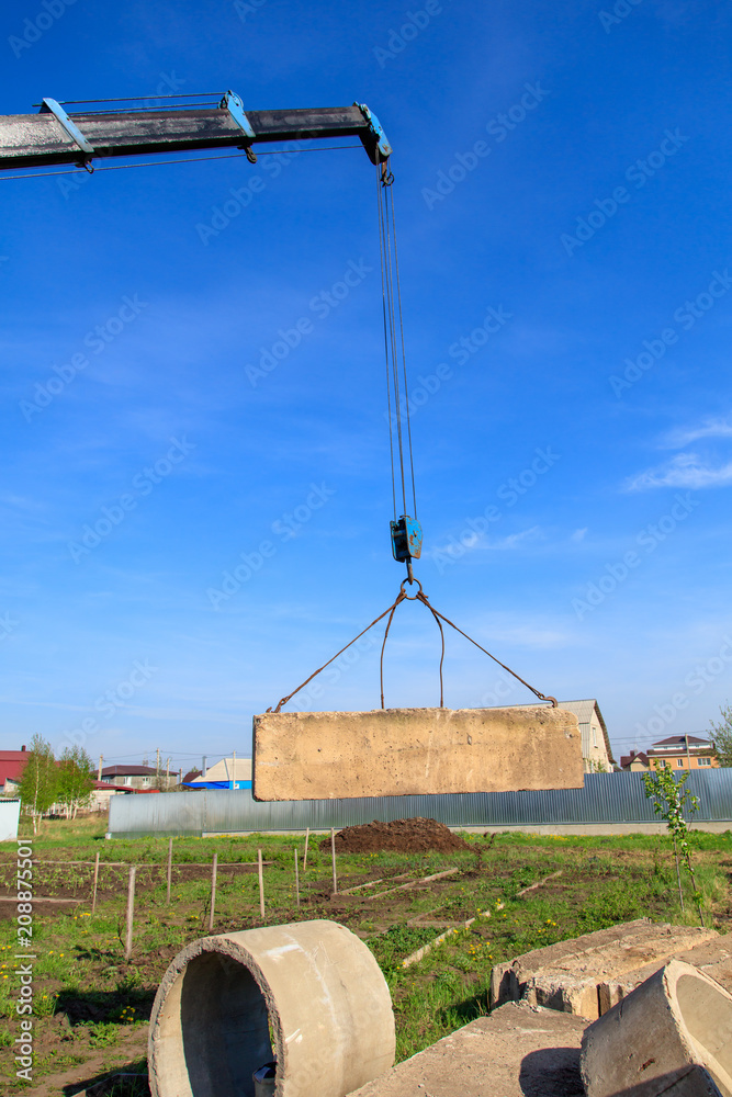 The crane loads old concrete blocks at the construction site The crane loads old concrete blocks at the construction site