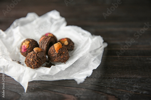 Tea balls on wooden background, closeup photo