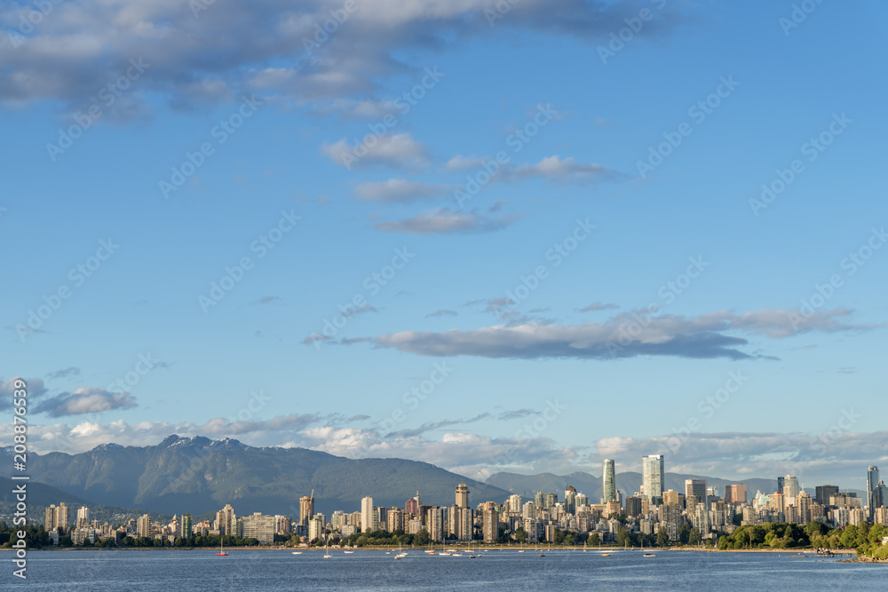 high-rise buildings of a modern city with mountains in the background