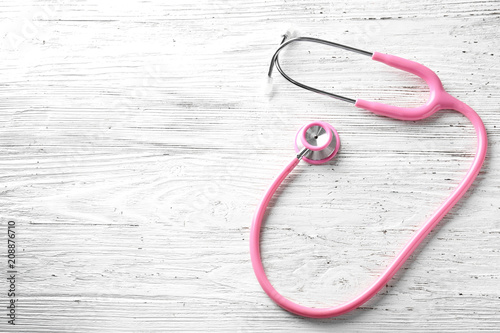 Stethoscope on wooden background. Health care concept