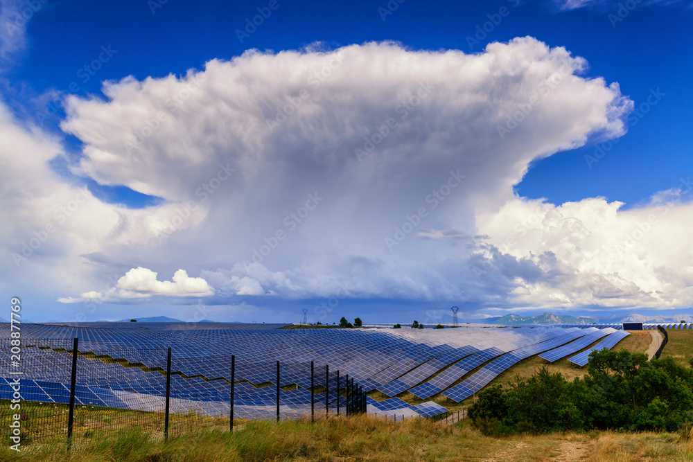 Giant thunderstorm cloud above solar power plant in Provance, France. Giant thunderstorm cloud above solar power plant in Provance, France.