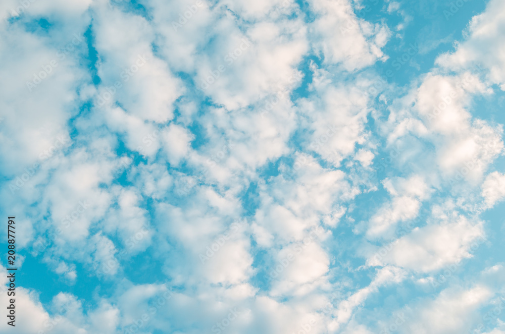 White clouds on a blue sky background.