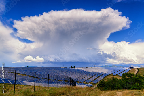 Giant thunderstorm cloud above solar power plant in Provance, France.