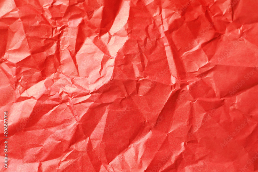 Obraz premium Vibrant red crumpled paper texture background with abstract folds and creases, rough surface detail for creative design, material