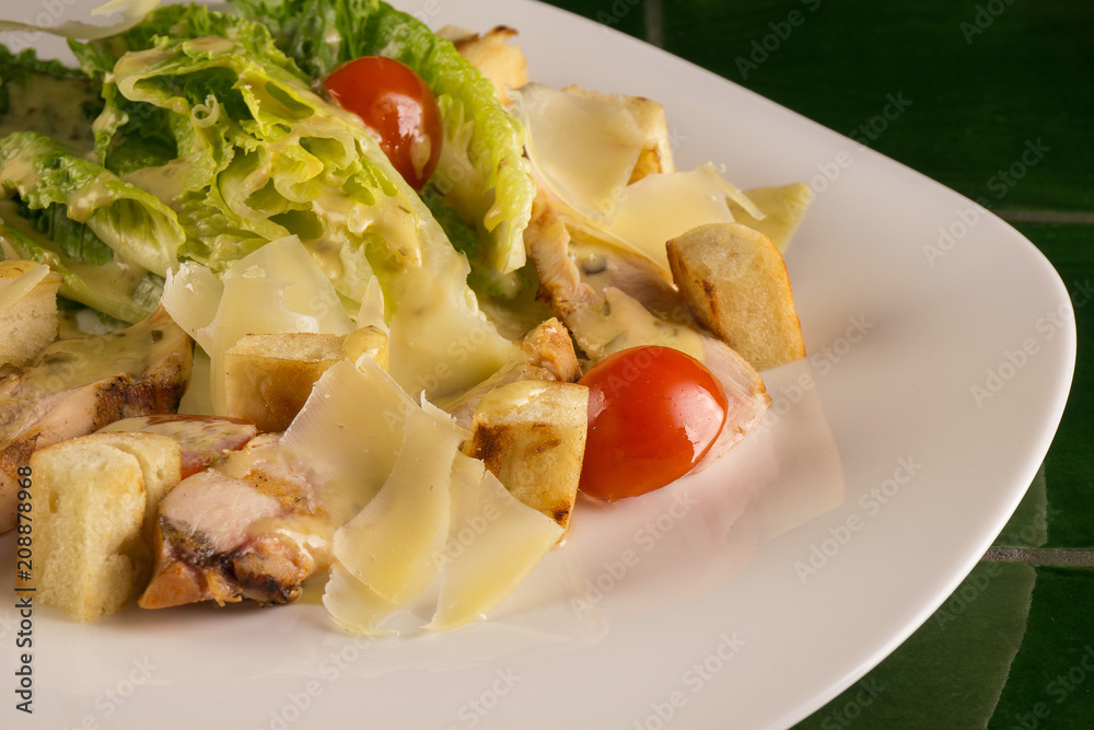 Caesar salad on a green background