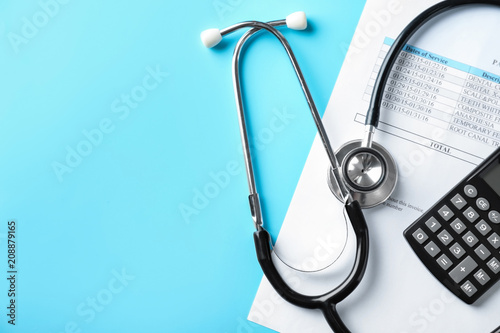 Stethoscope with calculator and price list on color background. Health care concept