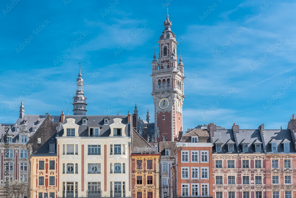 Lille, old facades in the center, the belfry of the Chambre de Commerce in background 
