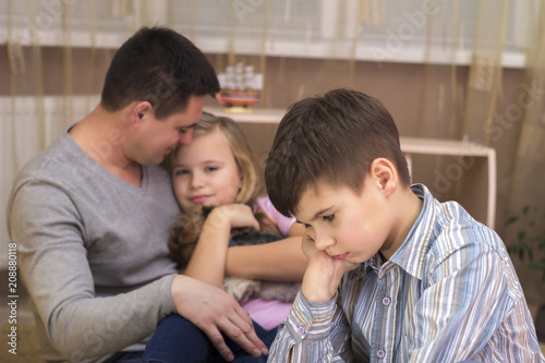 Fototapet The boy is jealous of his father's sister and sad.