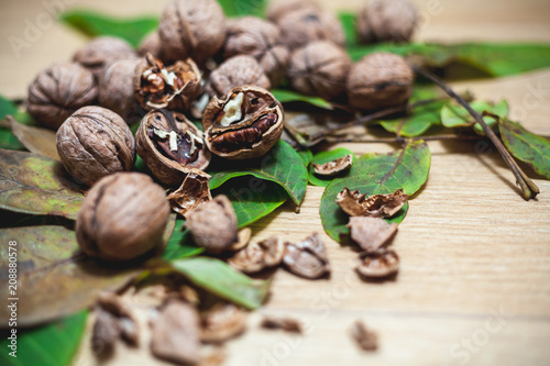 Several walnuts lie on brown background