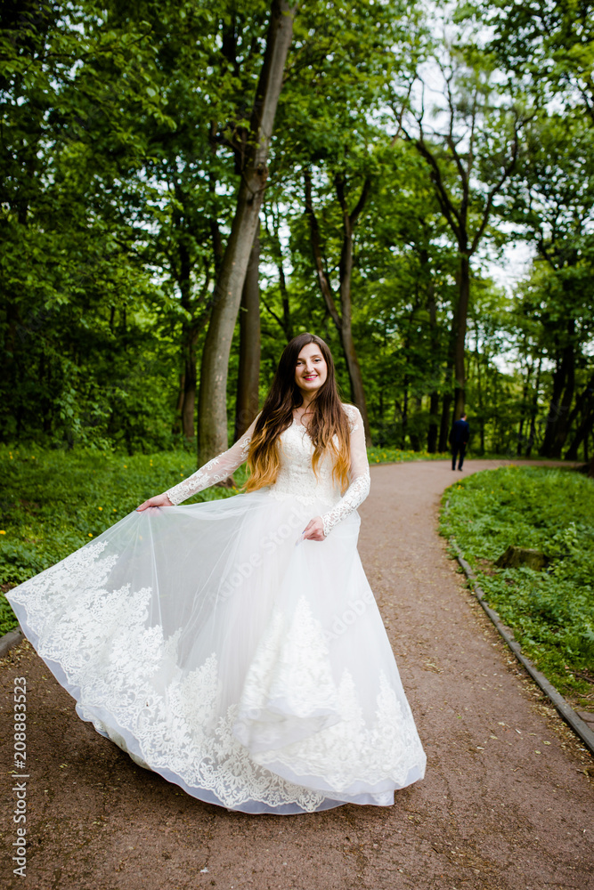 Sweet bride in the wedding dress is spinning