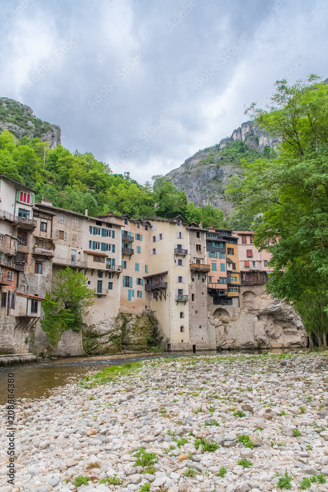 Pont-en-Royans in the Vercors, typical colorful houses built on the cliff, over the river, in France 
