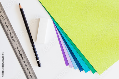 Stationery and colored cardstock on white desk