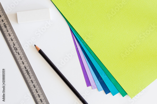 Stationery and colored cardstock on white desk