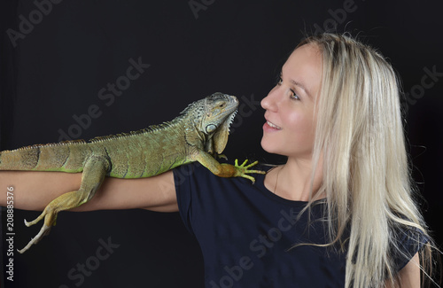 Beautiful girl portrait and green iguana
