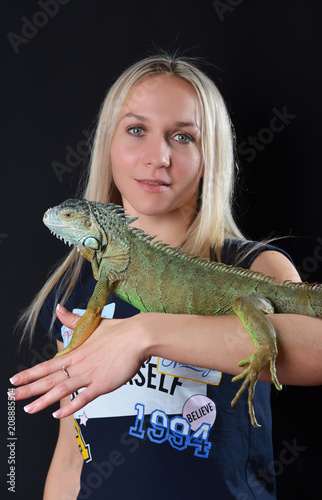 Beautiful girl portrait and green iguana
