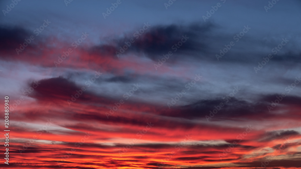sunset sky with orange clouds on the city. Background wallpaper