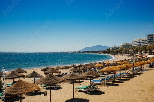 Beach with sun loungers in Marbella, Spain.
 photo