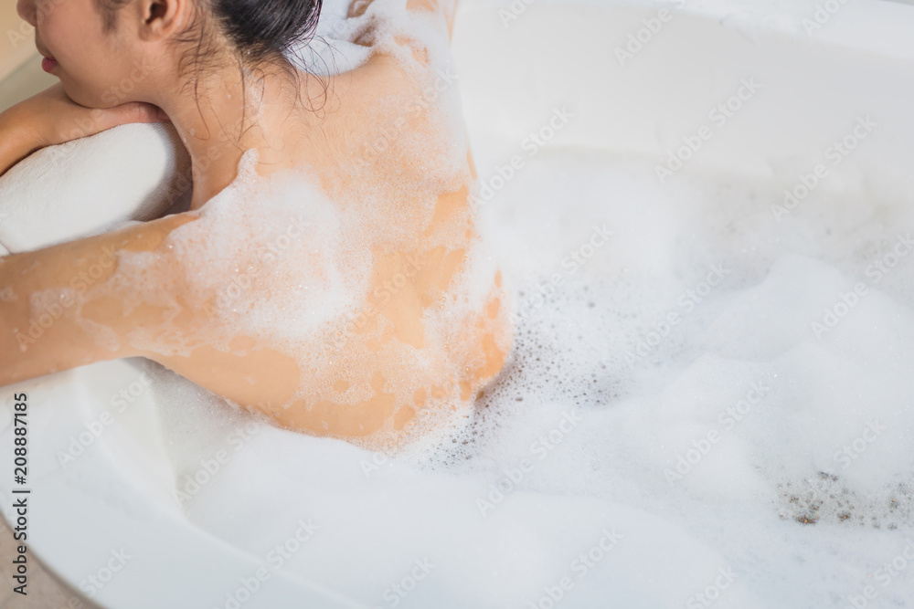 Women are using soap. cleanse the body she is in the bathtub Women are using soap. cleanse the body she is in the bathtub