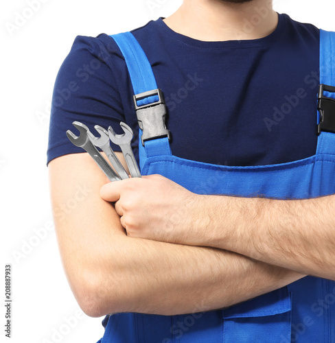 Male car mechanic with tools on white background, closeup