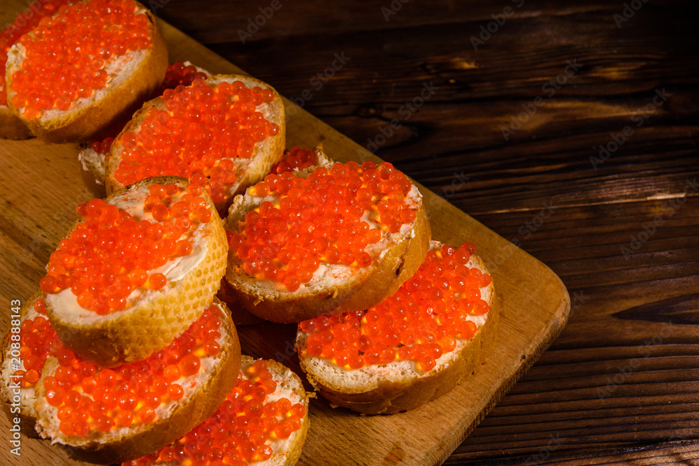 Sandwiches with red caviar on a cutting board Sandwiches with red caviar on a cutting board