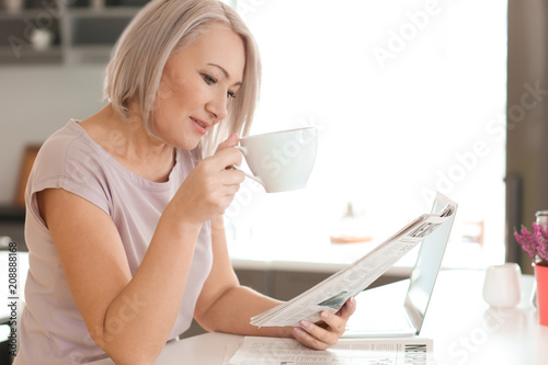 Mature woman drinking coffe...