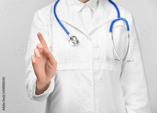 Female doctor showing something on white background