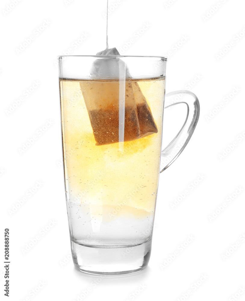 Brewing of hot beverage with tea bag in glass cup on white background Brewing of hot beverage with tea bag in glass cup on white background