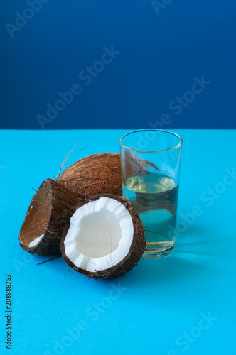 Whole coconuts and coconut water . Doutone background. photo