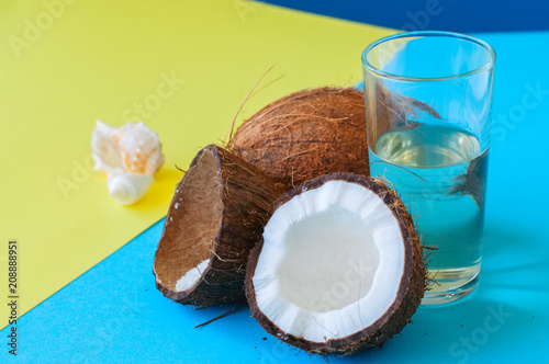 Whole coconuts and coconut water . Doutone background.