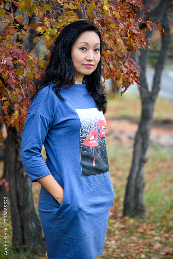 Fall woman smiling - Autumn portrait of happy lovely and beautiful mixed race Asian Caucasian young woman in forest in fall colors. Fall woman smiling - Autumn portrait of happy lovely and beautiful mixed race Asian Caucasian young woman in forest in fall colors.