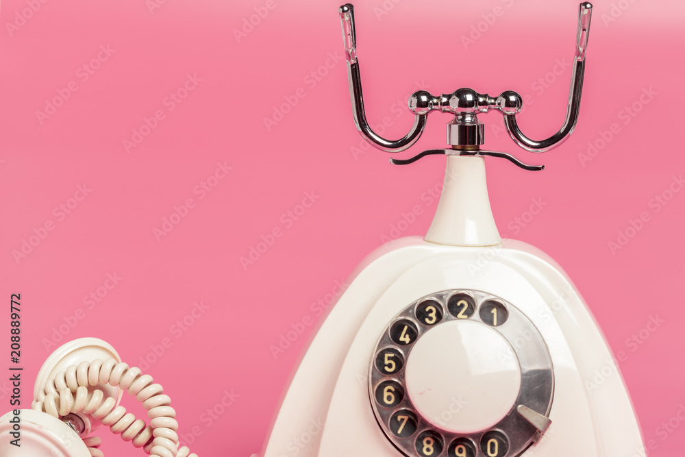 Retro white telephone on pink background Retro white telephone on pink background