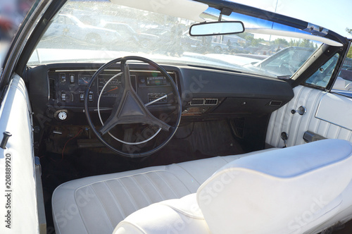 Fragment retro car dashboard.  White leather and black steering wheel. © RuskaDesign